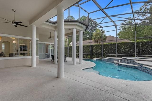 view of pool featuring a hot tub, a lanai, ceiling fan, and a patio area