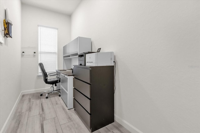 office with light wood-type flooring