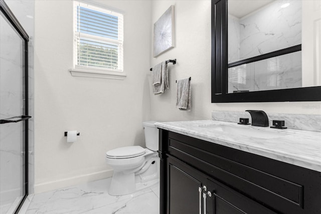 bathroom featuring vanity, a shower with shower door, and toilet