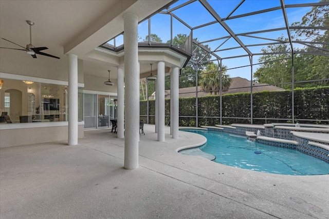 view of swimming pool featuring ceiling fan, a hot tub, a patio area, and glass enclosure