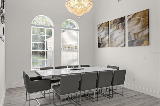 dining space with an inviting chandelier and light hardwood / wood-style floors