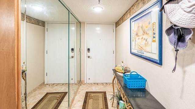 doorway featuring a textured ceiling