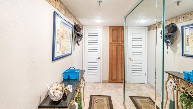 hallway with a textured ceiling