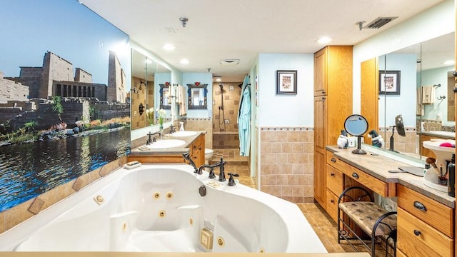 bathroom featuring tile patterned floors, vanity, tile walls, and independent shower and bath