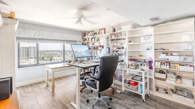 office with hardwood / wood-style flooring, a textured ceiling, and ceiling fan