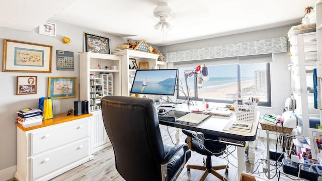 home office featuring light hardwood / wood-style floors and ceiling fan