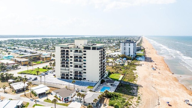 drone / aerial view featuring a view of the beach and a water view