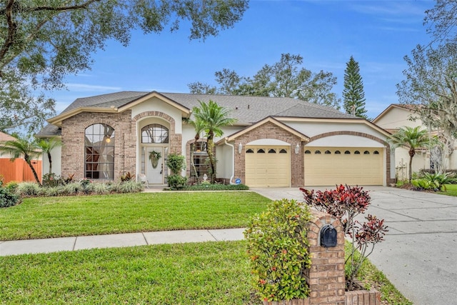 view of front of property featuring a front yard and a garage