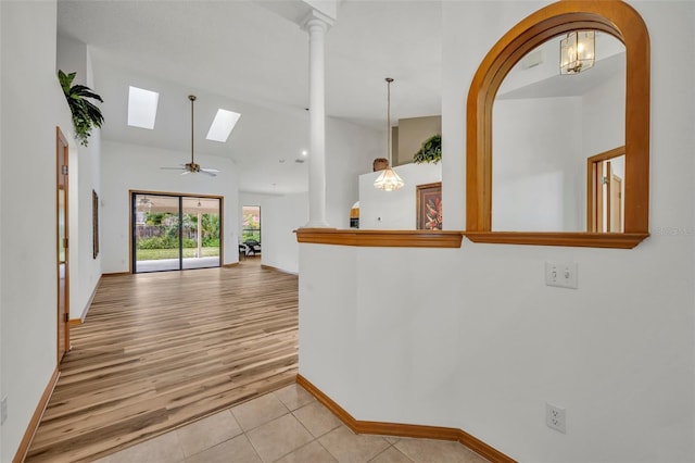 interior space with light tile patterned floors and lofted ceiling