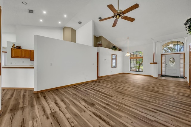 unfurnished living room featuring ceiling fan, light hardwood / wood-style floors, and high vaulted ceiling