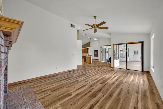 unfurnished living room featuring vaulted ceiling, ceiling fan, and light wood-type flooring