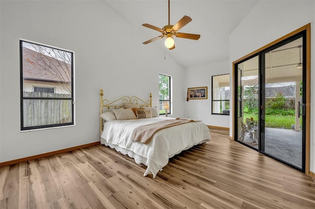 bedroom featuring ceiling fan, light hardwood / wood-style floors, access to outside, and high vaulted ceiling