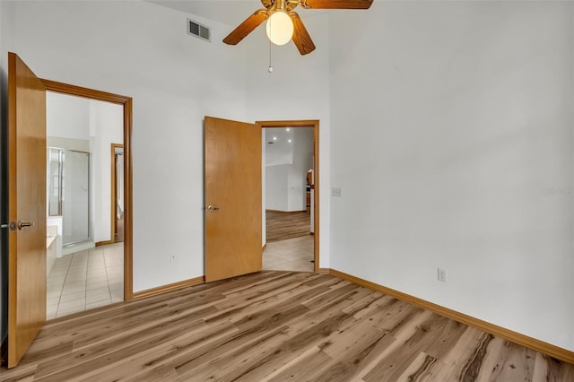 unfurnished bedroom with ceiling fan and light hardwood / wood-style floors