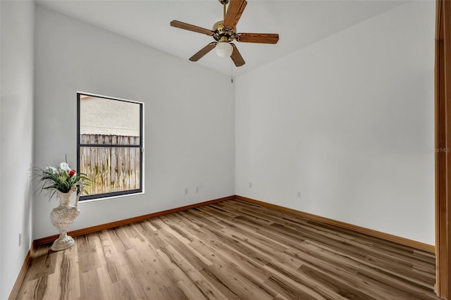 empty room with light wood-type flooring, ceiling fan, and lofted ceiling