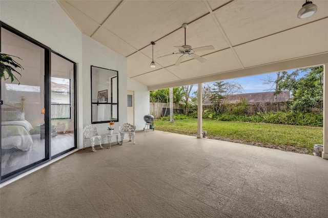 unfurnished sunroom with ceiling fan