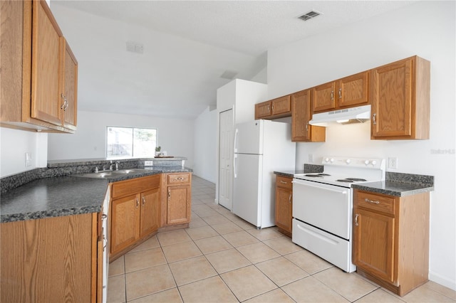 kitchen featuring lofted ceiling, sink, white appliances, light tile patterned floors, and kitchen peninsula