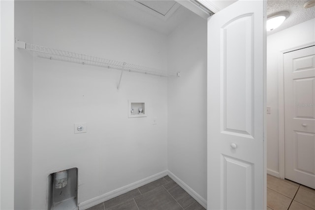 laundry area with washer hookup, tile patterned floors, electric dryer hookup, and a textured ceiling