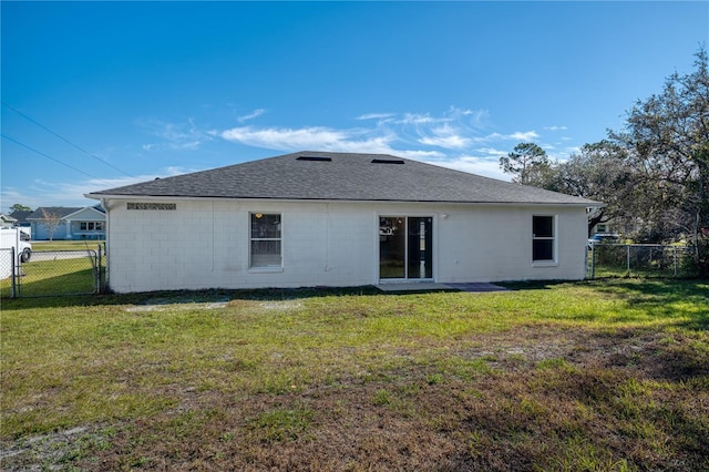 rear view of house with a lawn