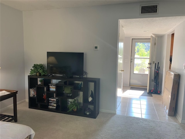 carpeted living room featuring a textured ceiling and radiator heating unit