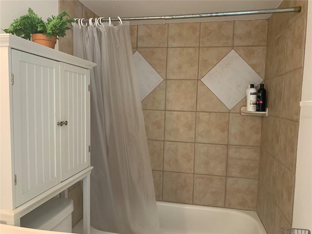 bathroom with toilet and shower / bath combo