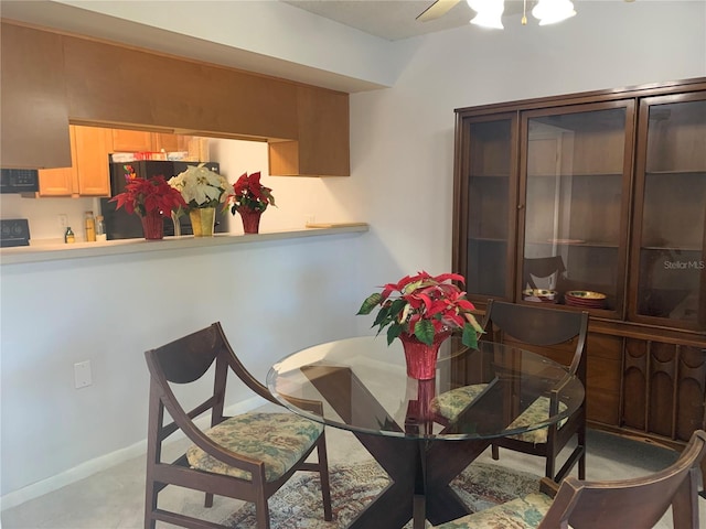 dining area with baseboards and a ceiling fan