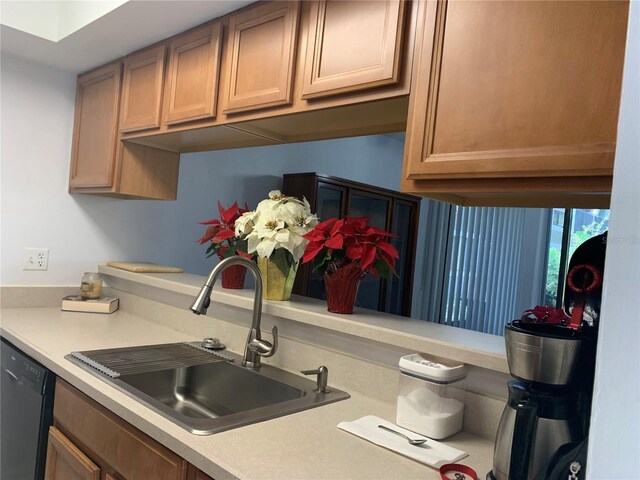 kitchen featuring a sink, dishwasher, and light countertops