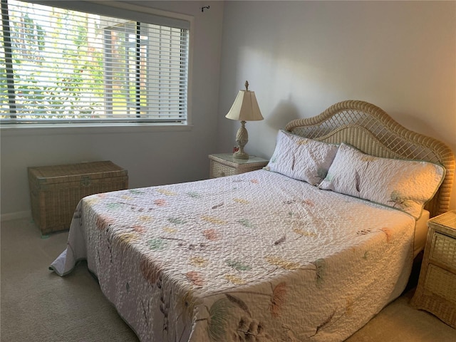 bedroom featuring carpet floors and baseboards