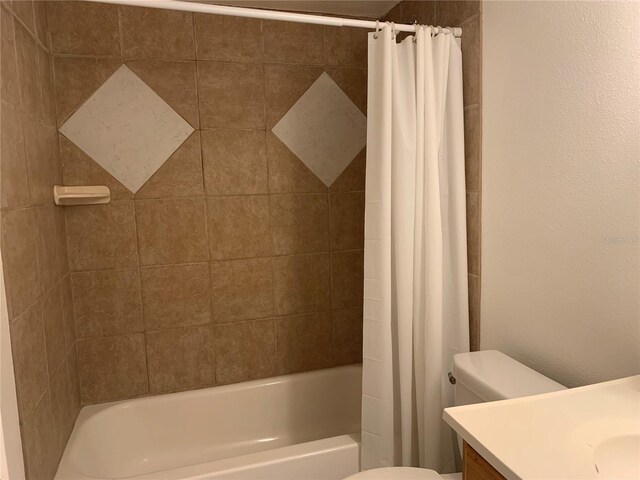 full bath featuring vanity, shower / bath combo, and toilet