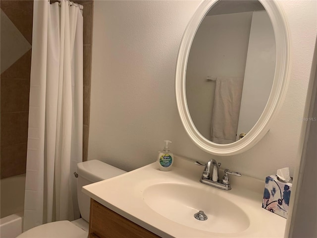 bathroom featuring vanity, shower / bath combo, and toilet
