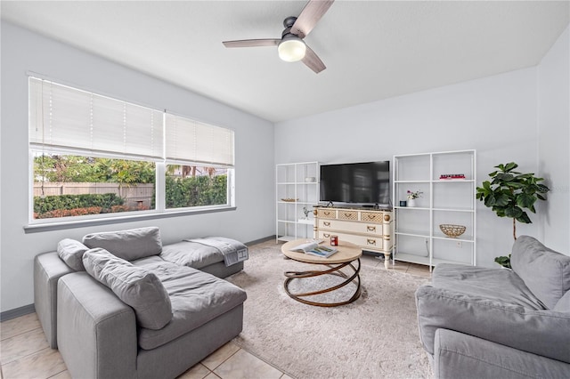 living room featuring light tile patterned floors and ceiling fan