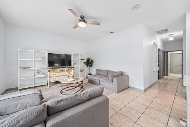 tiled living room with ceiling fan