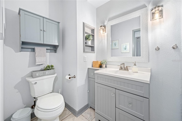 bathroom featuring tile patterned flooring, vanity, and toilet