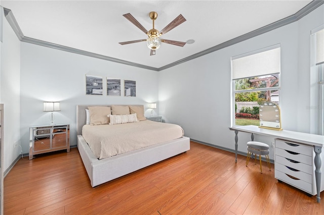 bedroom with hardwood / wood-style floors, crown molding, and ceiling fan