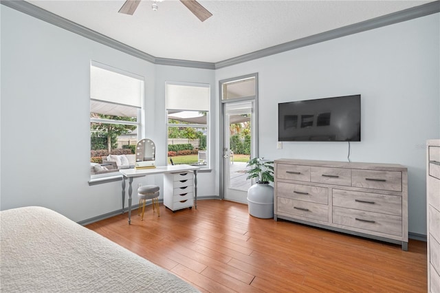 bedroom with crown molding, light wood-type flooring, a textured ceiling, and ceiling fan