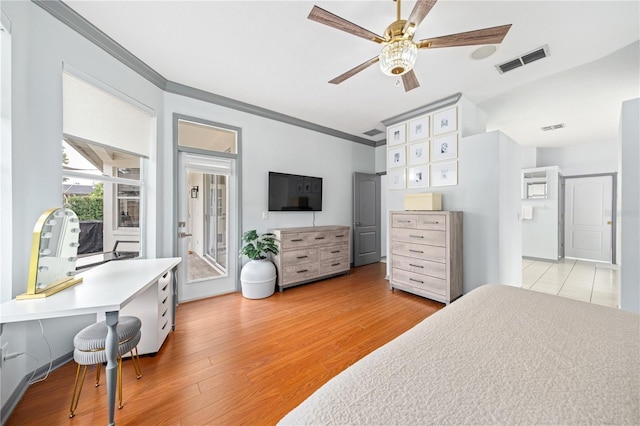 bedroom featuring crown molding, ceiling fan, ensuite bath, and light hardwood / wood-style flooring