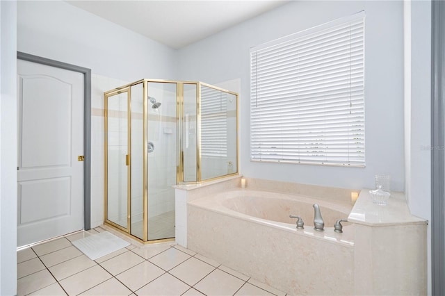 bathroom featuring shower with separate bathtub and tile patterned flooring