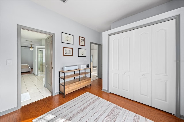 bedroom with hardwood / wood-style floors and a closet