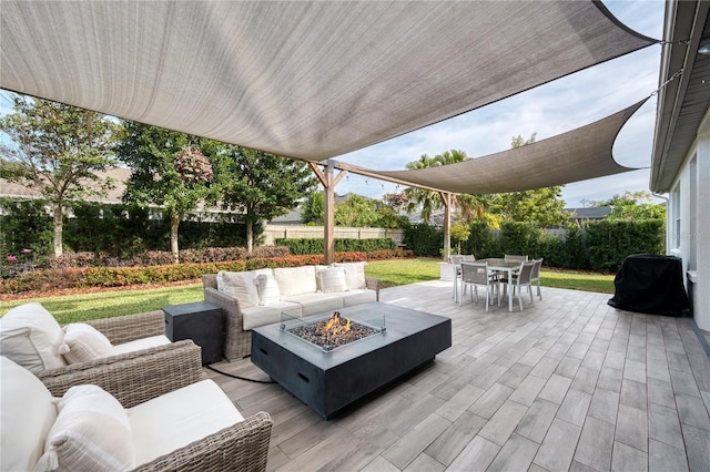 view of patio featuring area for grilling and an outdoor living space with a fire pit