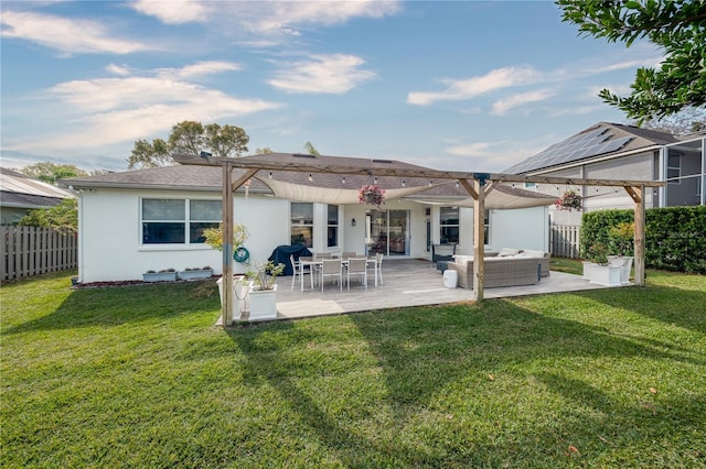 rear view of house featuring a lawn, outdoor lounge area, and a patio