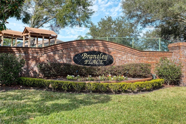 community / neighborhood sign with a lawn