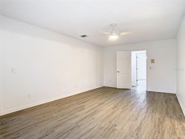 empty room with hardwood / wood-style flooring and ceiling fan