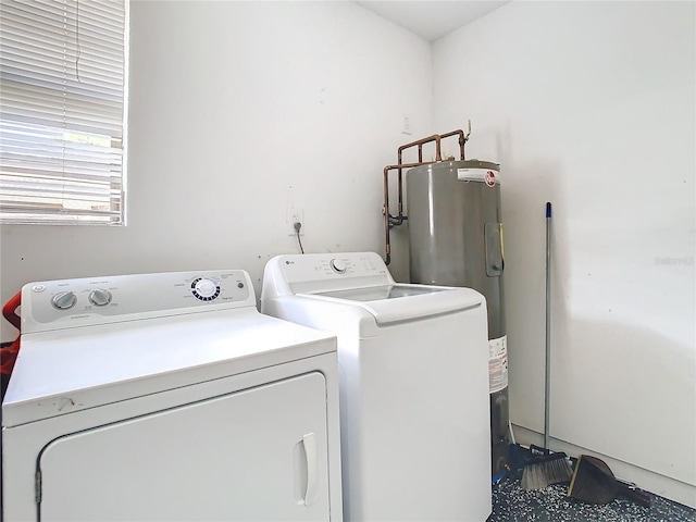 washroom featuring electric water heater and washer and clothes dryer