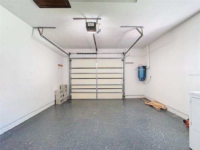 garage with a garage door opener and washer / dryer