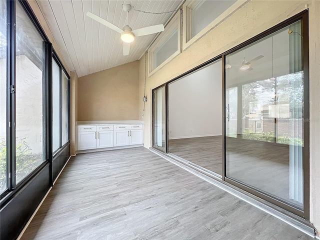 unfurnished sunroom featuring ceiling fan and wood ceiling