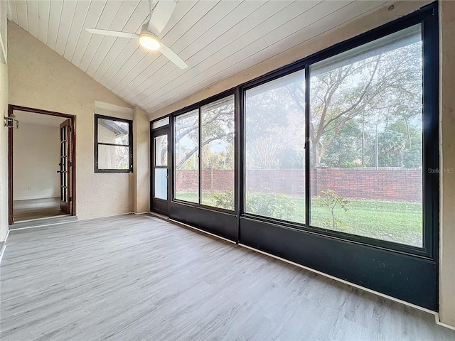 unfurnished sunroom with ceiling fan, wood ceiling, and vaulted ceiling