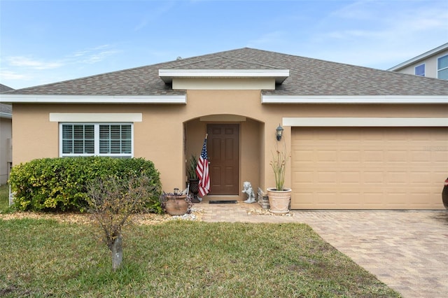 view of front facade with a garage and a front lawn