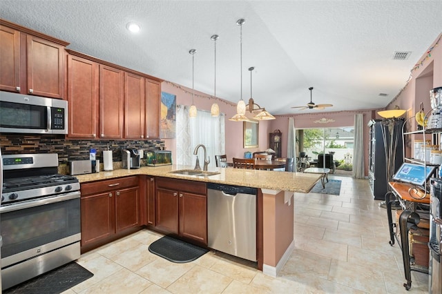 kitchen featuring ceiling fan, sink, pendant lighting, decorative backsplash, and appliances with stainless steel finishes