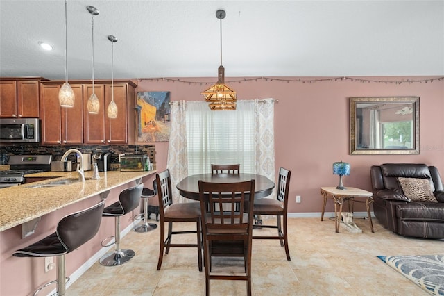 dining area featuring a textured ceiling and sink