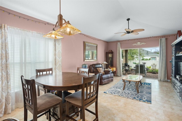 dining area with ceiling fan and vaulted ceiling