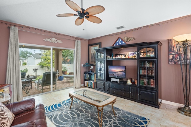 tiled living room with ceiling fan